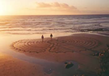 Sun setting over sandy coastline