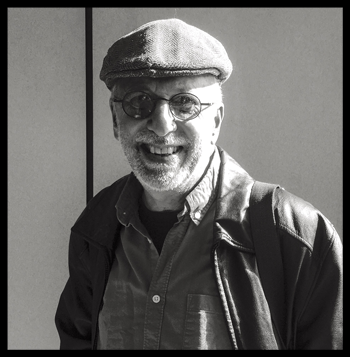 Grayscale photo of man in hat