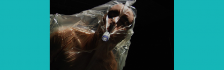 Head and torso of man covered in plastic